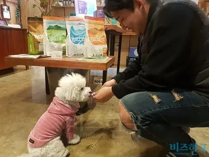 박민수 로렌츠 대표가 서울 서대문구에 위치한 매장에서 반려견에게 간식을 먹이고 있다. 사진=박현광 기자