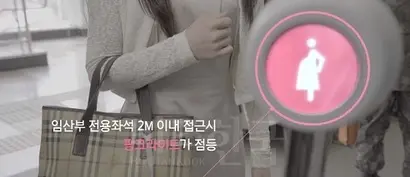 부산시가 도입한 핑크라이트. ‘비콘(무선발신기)’을 소지한 임산부가 지하철에 탑승한 뒤 소지하고 있는 비콘 버튼을 누르면 차량 내 수신기에 핑크빛 불이 켜지고 자리 양보 안내 음성이 흘러나온다. 사진=부산시 유튜브
