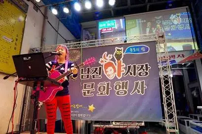 먹거리 판매대 끝에는 앉아서 음식을 먹거나 쉴 수 있는 의자와 탁자가 있고, 그 앞에서는 라이브 공연이 펼쳐진다. 사진=구완회 제공